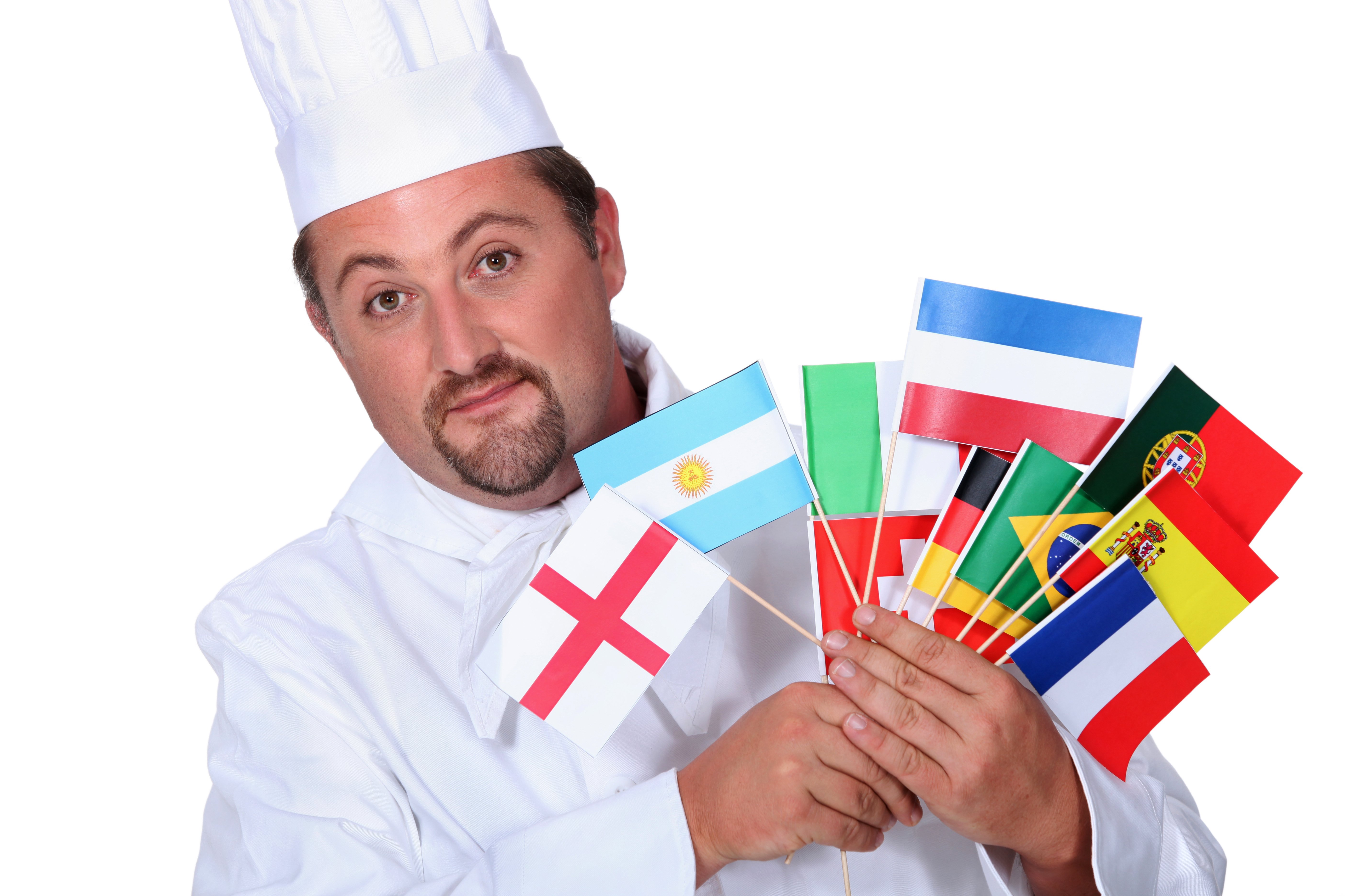 A chef holds many small flags of different nations. 